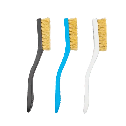 three plastic brushes with boar hair bristles used for rock climbing