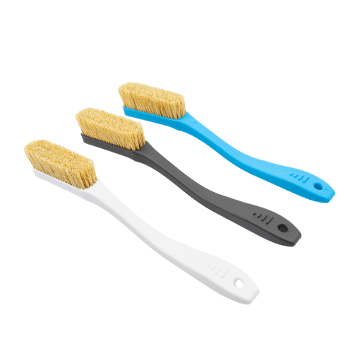 three plastic brushes with boar hair bristles used for rock climbing